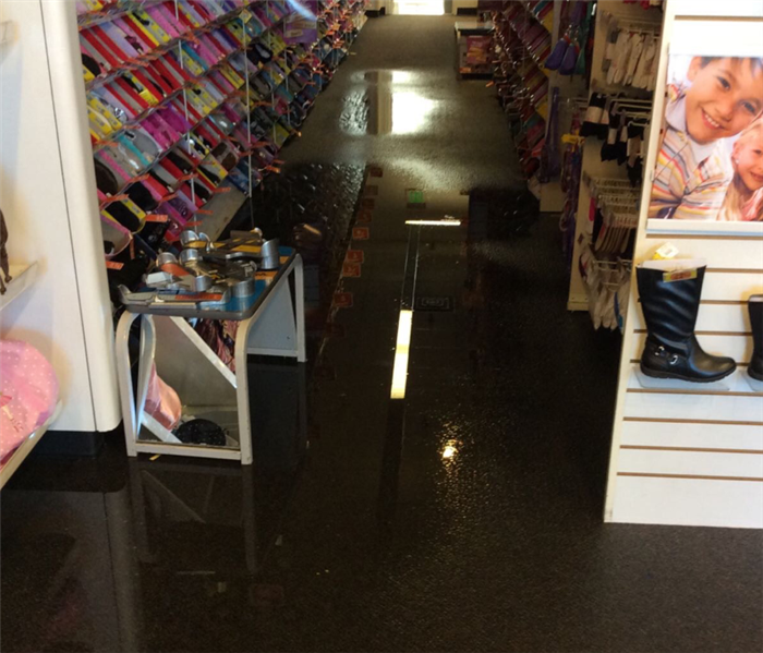 Store aisle with visible water puddles