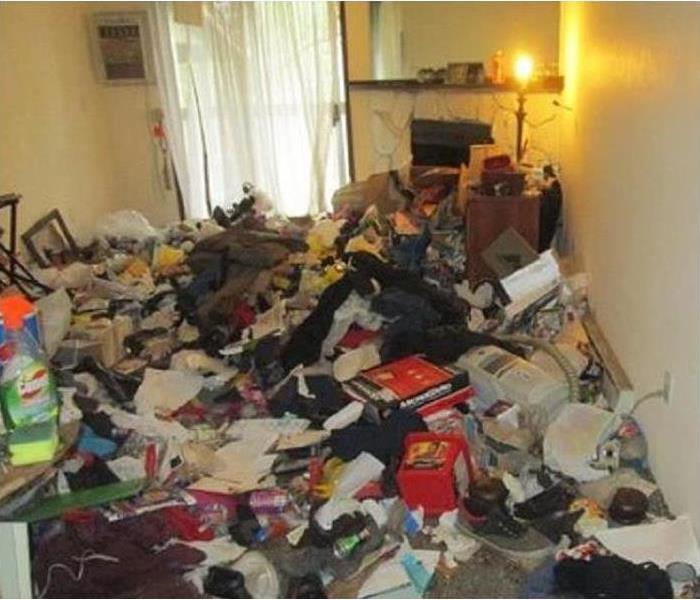 Home of a hoarder with piles of garbage.